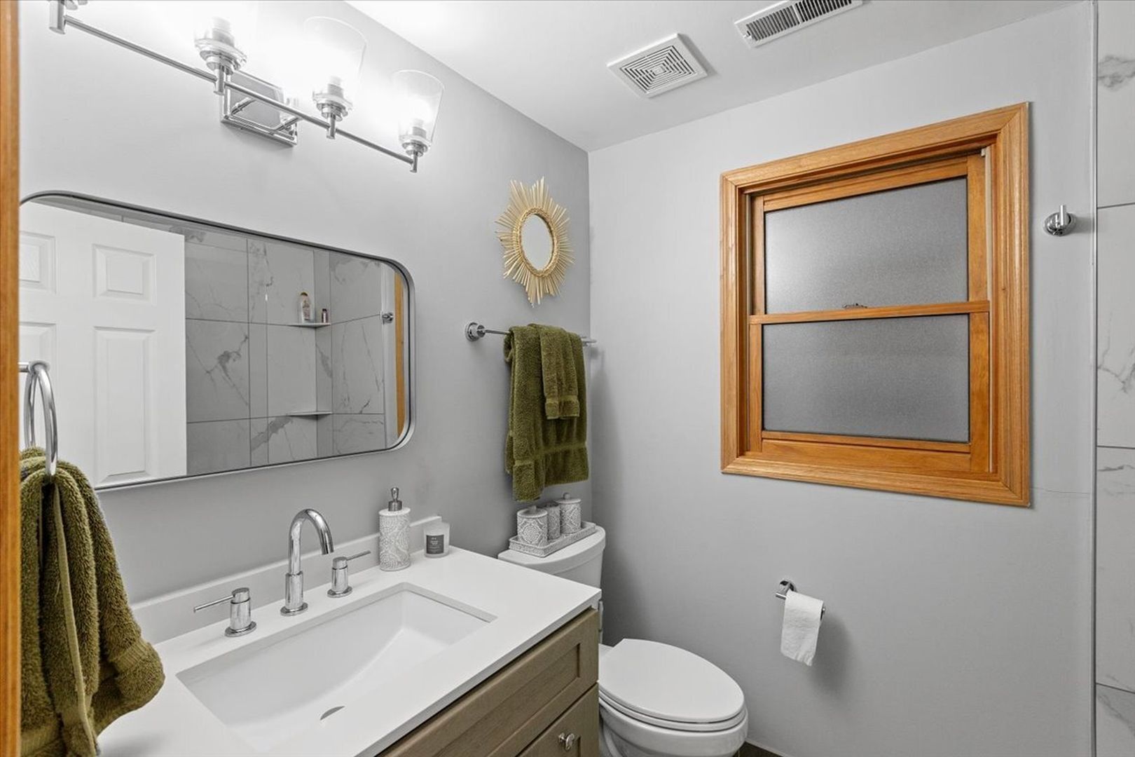 2033 West Huron Street, Unit 1 Chicago, IL 60612 - Photo 7 of 8 a bathroom with a sink vanity mirror and toilet