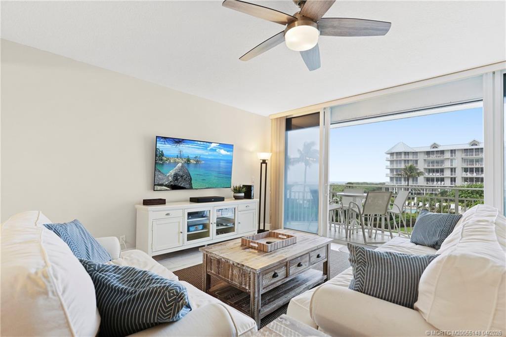 579 Northeast Plantation Road, Unit N107 Jensen Beach, FL 34957 - Photo 13 of 44 a living room with furniture and a flat screen tv