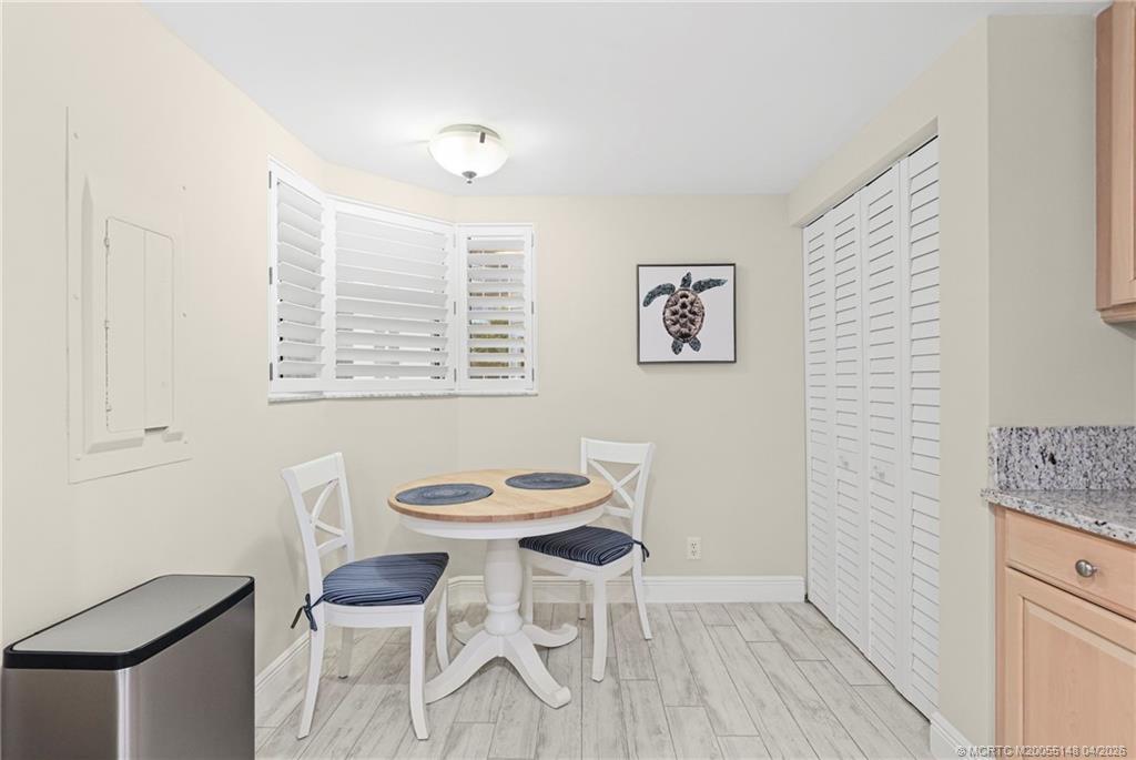 579 Northeast Plantation Road, Unit N107 Jensen Beach, FL 34957 - Photo 19 of 44 a view of a room with furniture and wooden floor