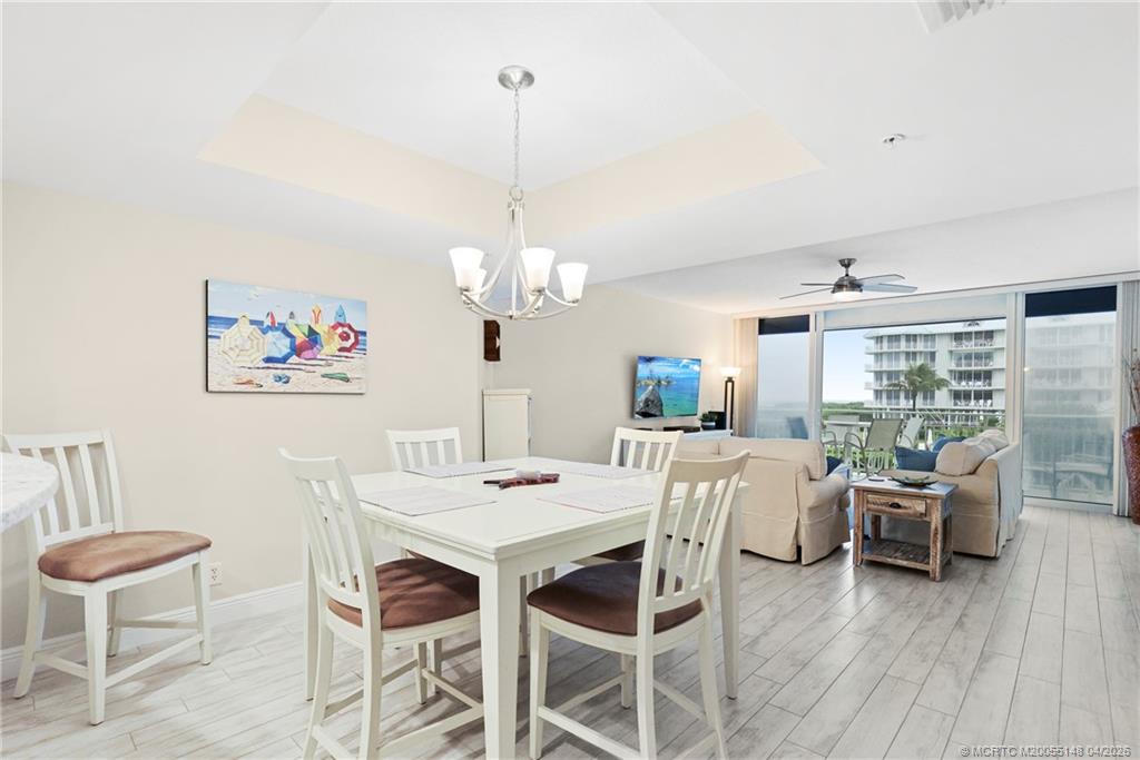 579 Northeast Plantation Road, Unit N107 Jensen Beach, FL 34957 - Photo 22 of 44 a view of a dining room with furniture window and wooden floor