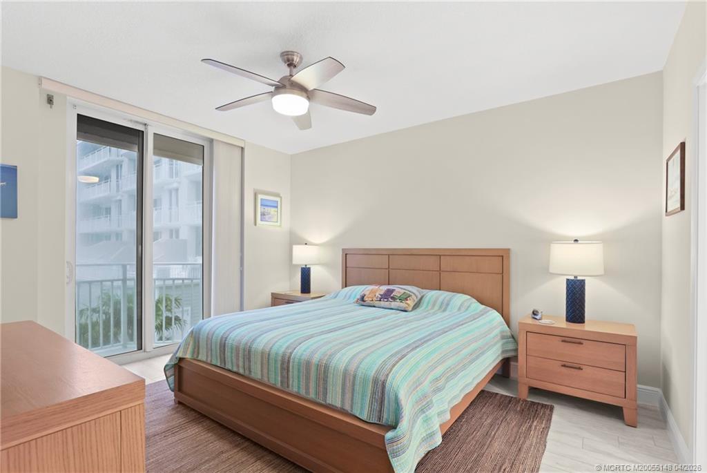 579 Northeast Plantation Road, Unit N107 Jensen Beach, FL 34957 - Photo 25 of 44 a bedroom with a bed and wooden floor