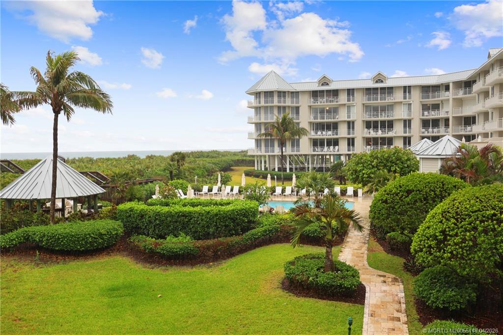 579 Northeast Plantation Road, Unit N107 Jensen Beach, FL 34957 - Photo 36 of 44 a view of a lake and a garden