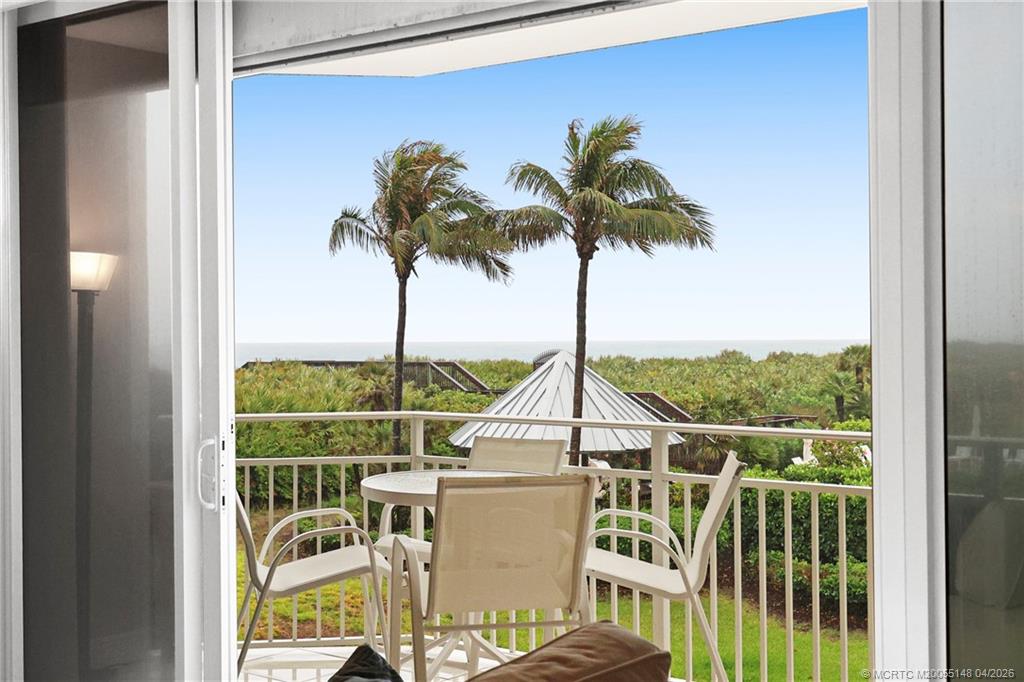 579 Northeast Plantation Road, Unit N107 Jensen Beach, FL 34957 - Photo 38 of 44 a view of a balcony with furniture