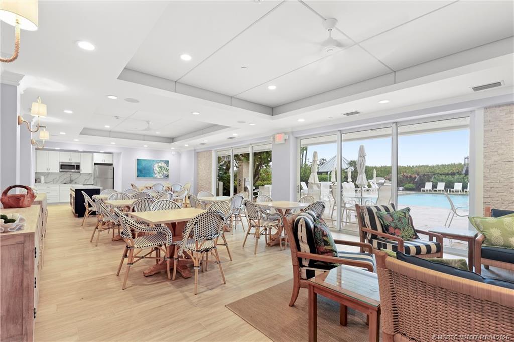 579 Northeast Plantation Road, Unit N107 Jensen Beach, FL 34957 - Photo 39 of 44 a view of a dining room with furniture window and outside view