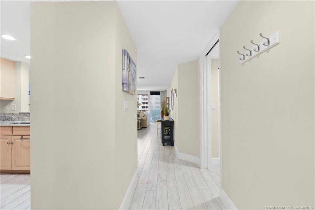 579 Northeast Plantation Road, Unit N107 Jensen Beach, FL 34957 - Photo 10 of 44 a view of a hallway with wooden floor and entryway