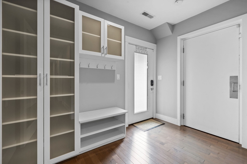 202 Rawson Road, Unit 3 Brookline, MA 02445 - Photo 12 of 17 a view of an empty room with wooden floor and closet