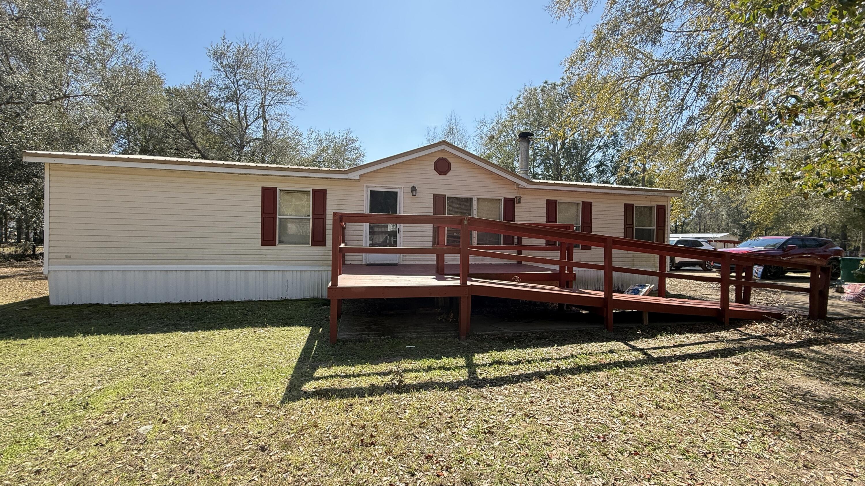 a view of a house with a yard and sitting area