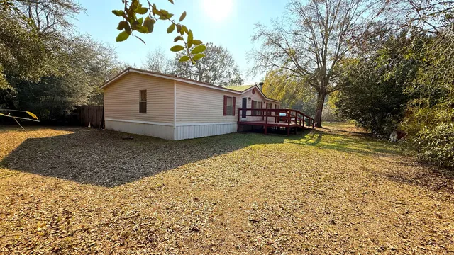 a view of a house with a yard and pathway