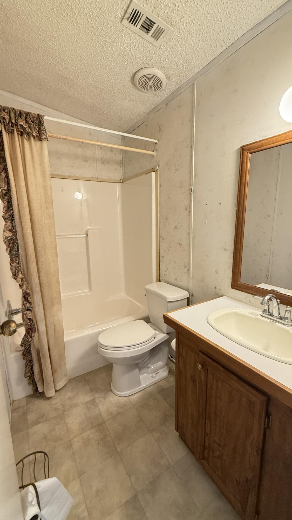 5243 Morris Street Crestview, FL 32539 - Photo 15 of 25 a bathroom with a sink a toilet and a shower