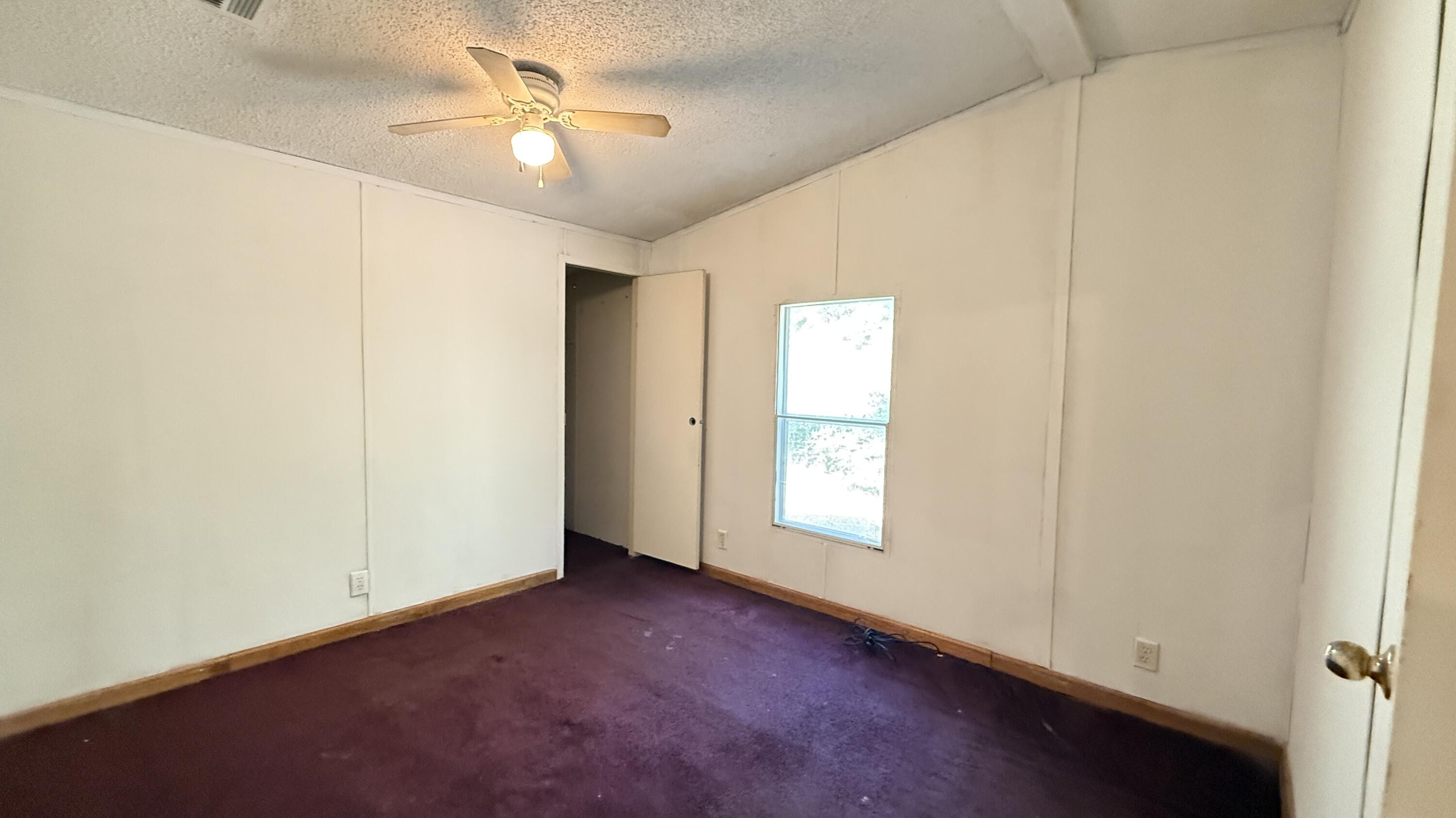 5243 Morris Street Crestview, FL 32539 - Photo 16 of 25 an empty room with windows and fan