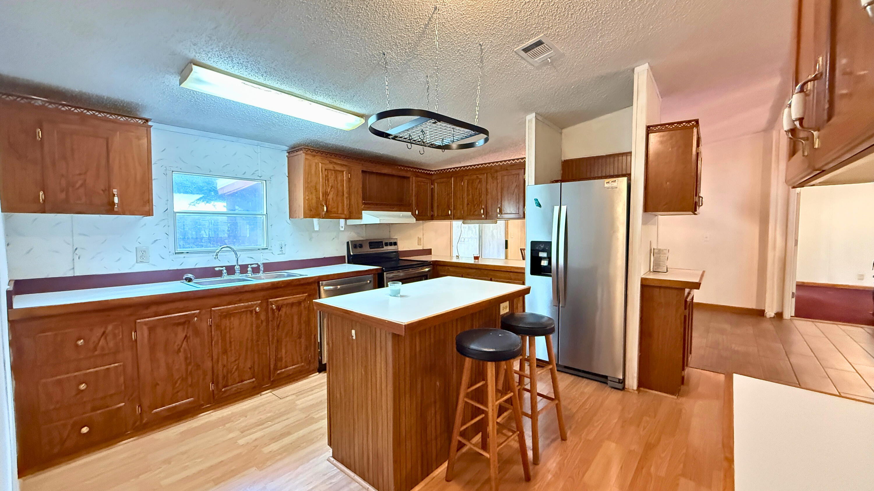 5243 Morris Street Crestview, FL 32539 - Photo 2 of 25 a kitchen with stainless steel appliances granite countertop a refrigerator and a stove top oven