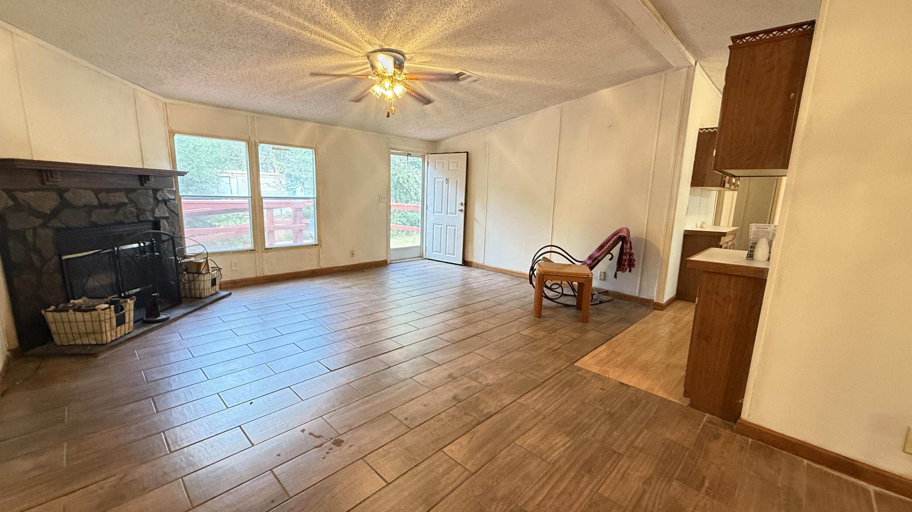 5243 Morris Street Crestview, FL 32539 - Photo 3 of 25 a view of a livingroom with furniture a ceiling fan and window
