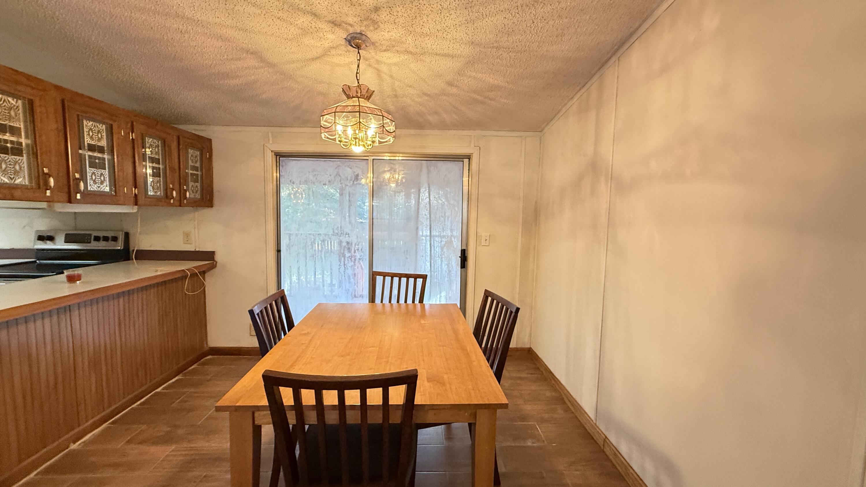 5243 Morris Street Crestview, FL 32539 - Photo 4 of 25 a view of a dining room with furniture window and wooden floor
