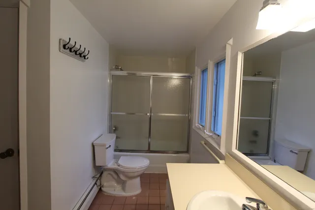 a bathroom with a toilet and a shower