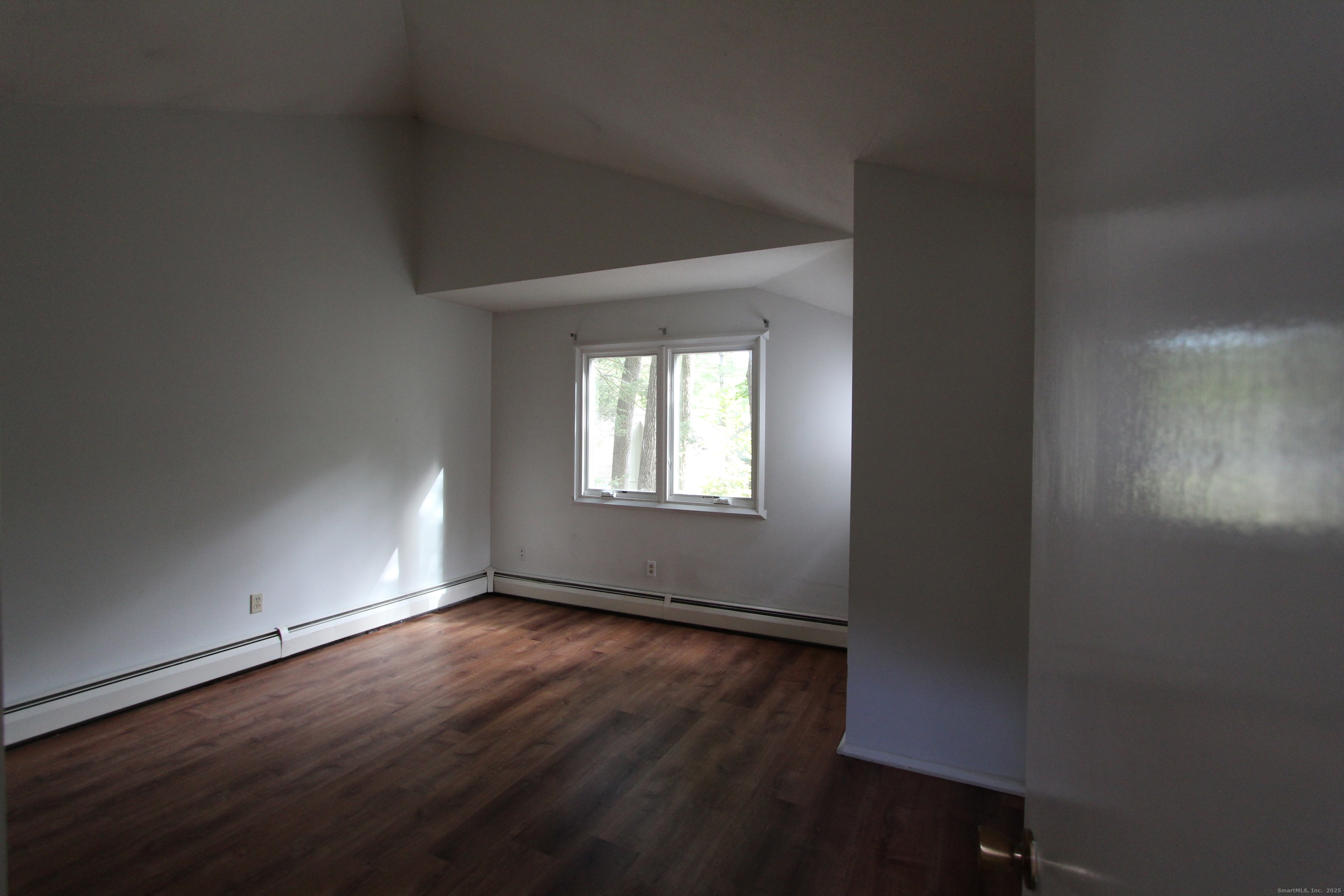 6 Lyle Court, Unit C Farmington, CT 06032 - Photo 15 of 34 an empty room with wooden floor and windows