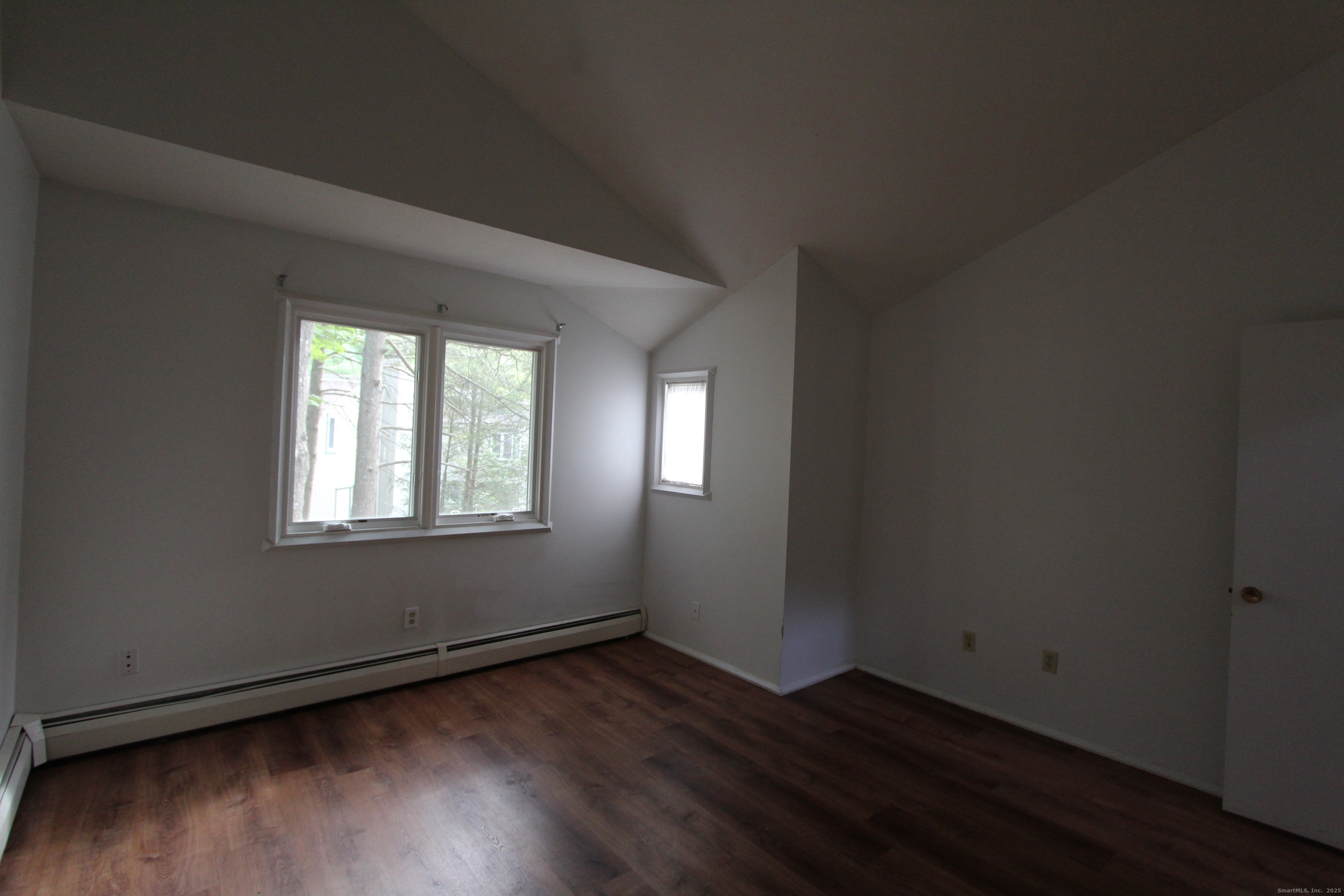 6 Lyle Court, Unit C Farmington, CT 06032 - Photo 17 of 34 an empty room with wooden floor and windows