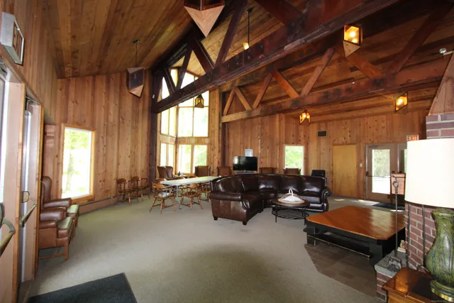 a living room with furniture a window and gym equipment
