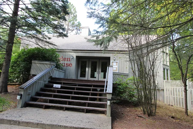 a view of a house with a tree front of house