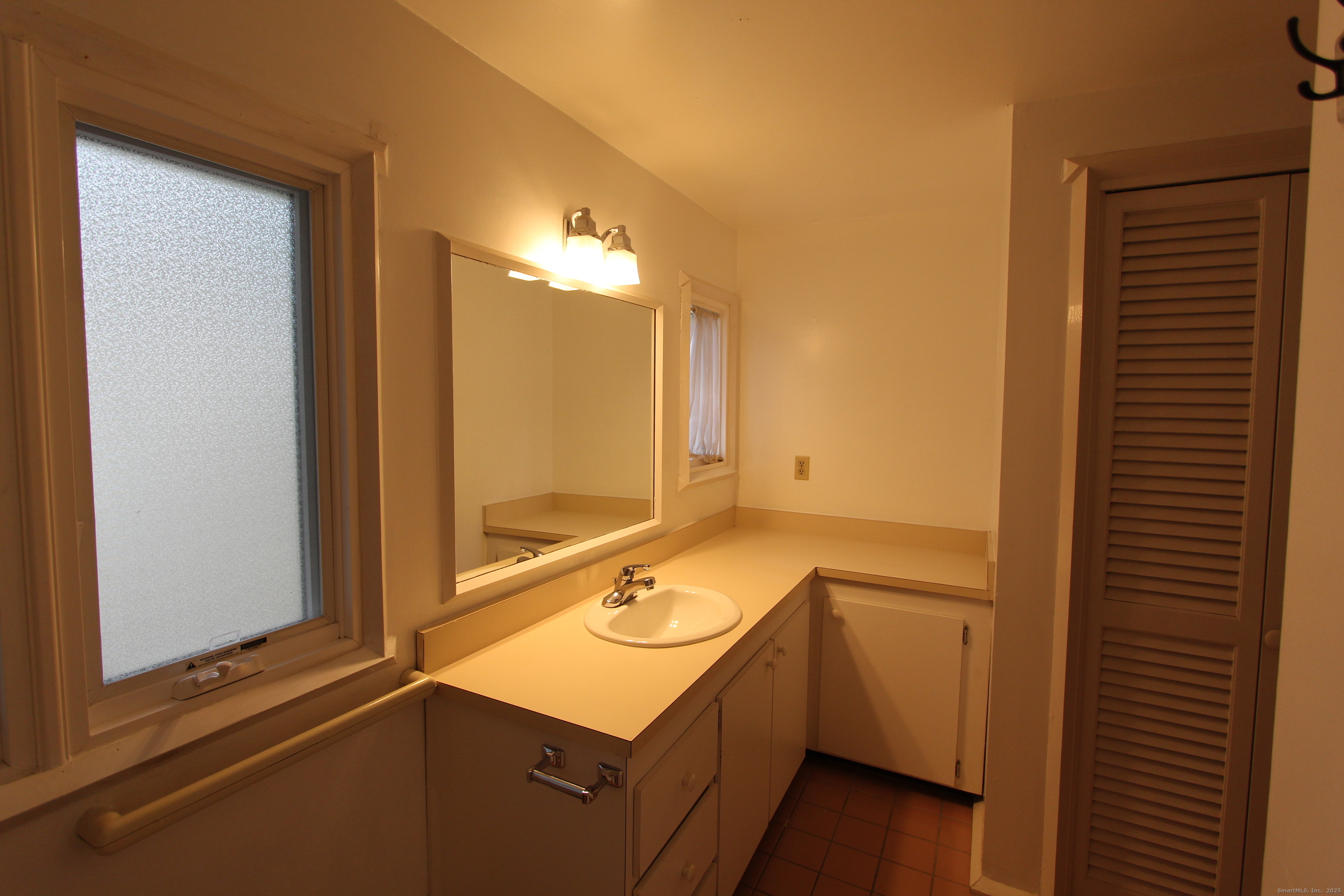 6 Lyle Court, Unit C Farmington, CT 06032 - Photo 22 of 34 a bathroom with a sink and a mirror