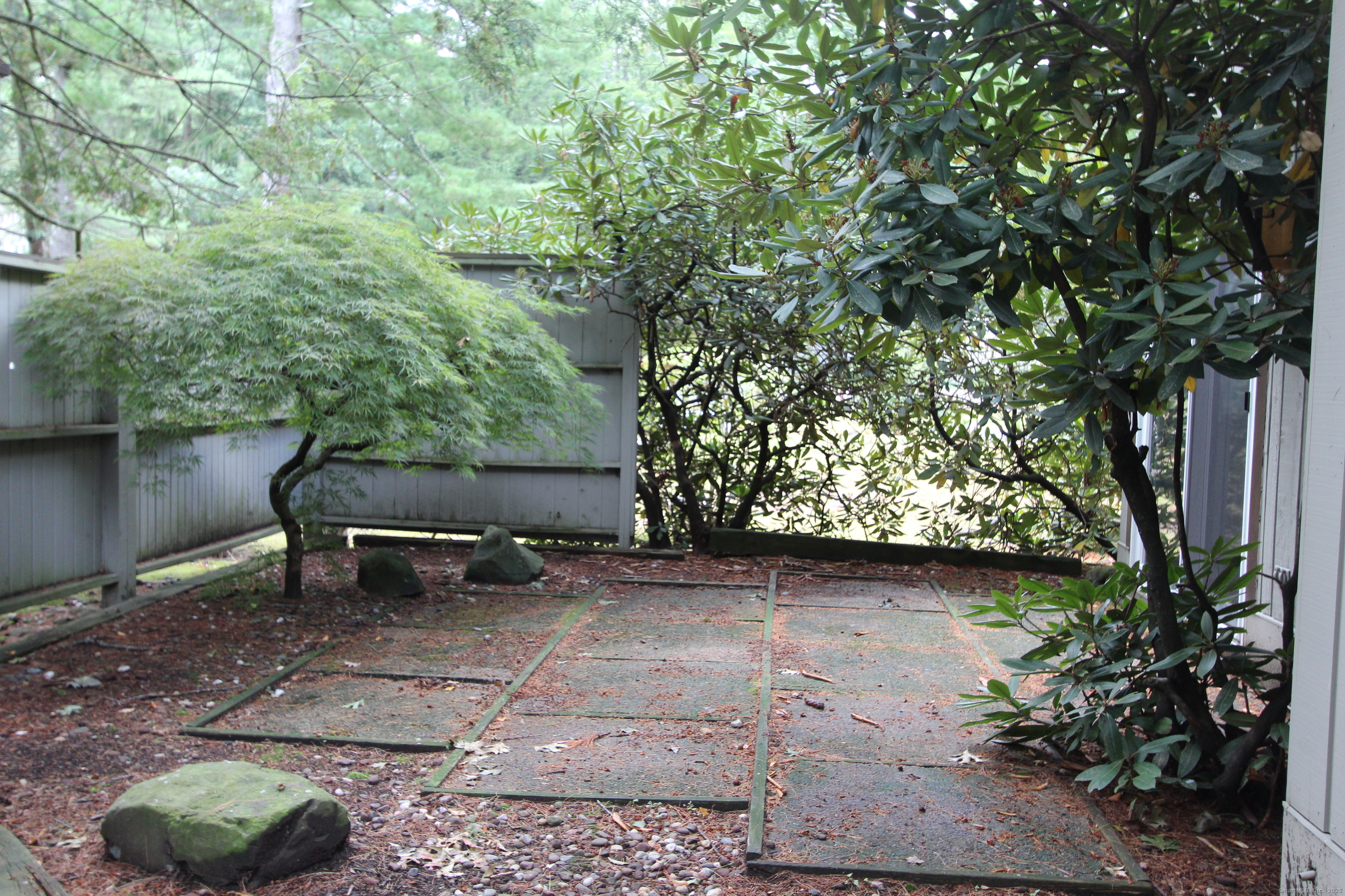 6 Lyle Court, Unit C Farmington, CT 06032 - Photo 27 of 34 a view of a bench in a backyard of a house