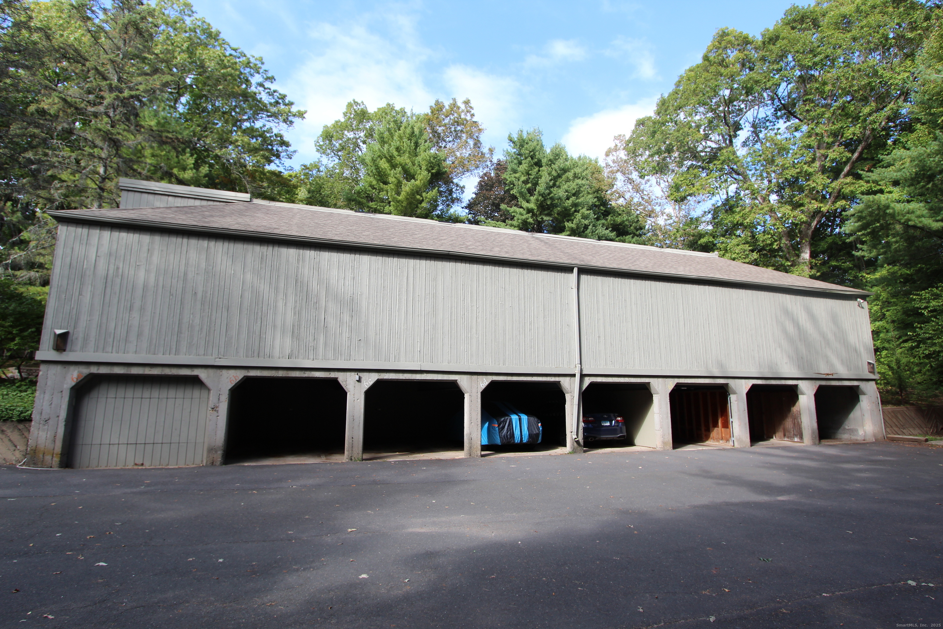 6 Lyle Court, Unit C Farmington, CT 06032 - Photo 3 of 34 a couple of table and chairs under an umbrella