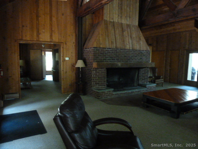 6 Lyle Court, Unit C Farmington, CT 06032 - Photo 32 of 34 a living room with furniture and a fireplace