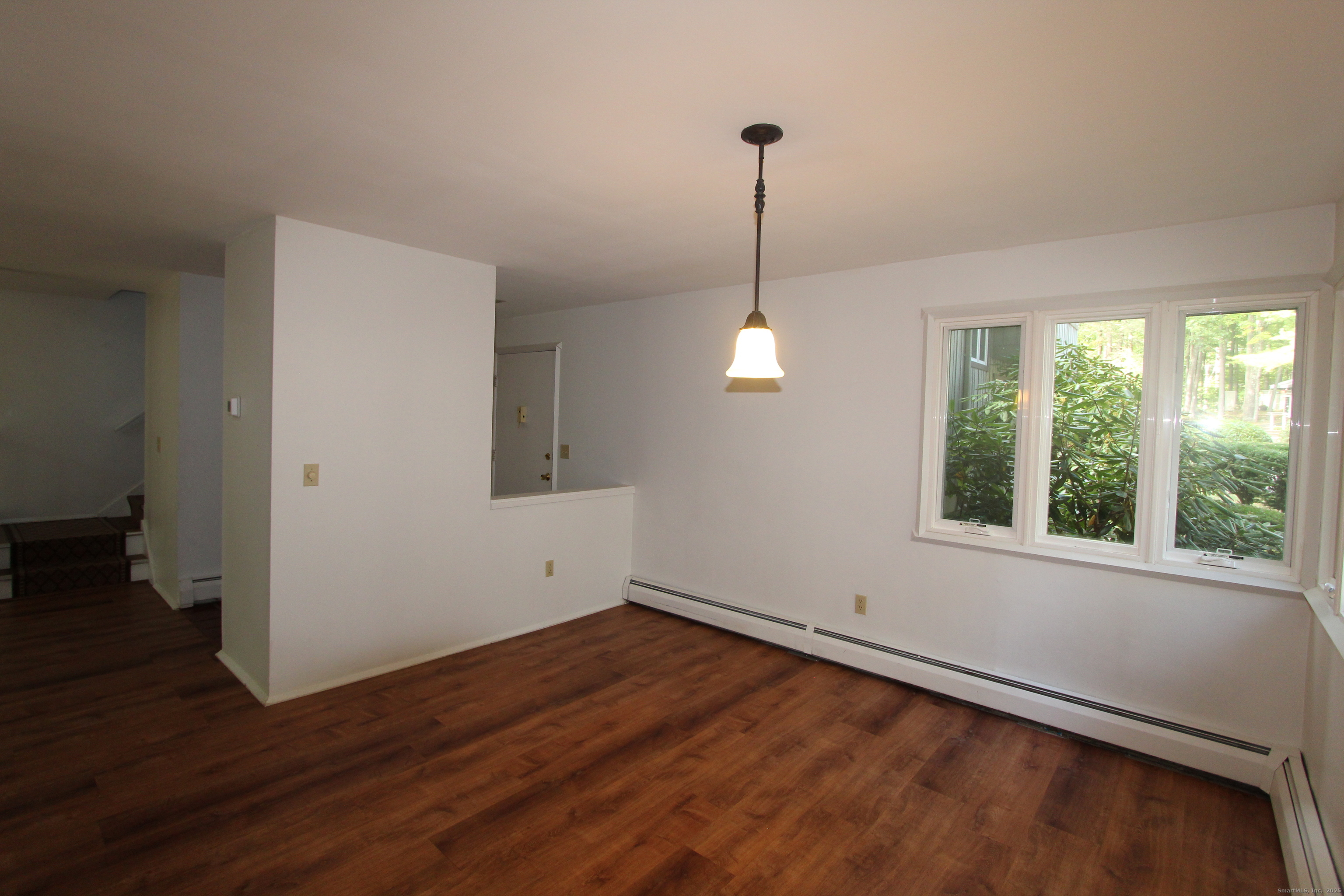 6 Lyle Court, Unit C Farmington, CT 06032 - Photo 4 of 34 a view of an empty room with wooden floor and a window