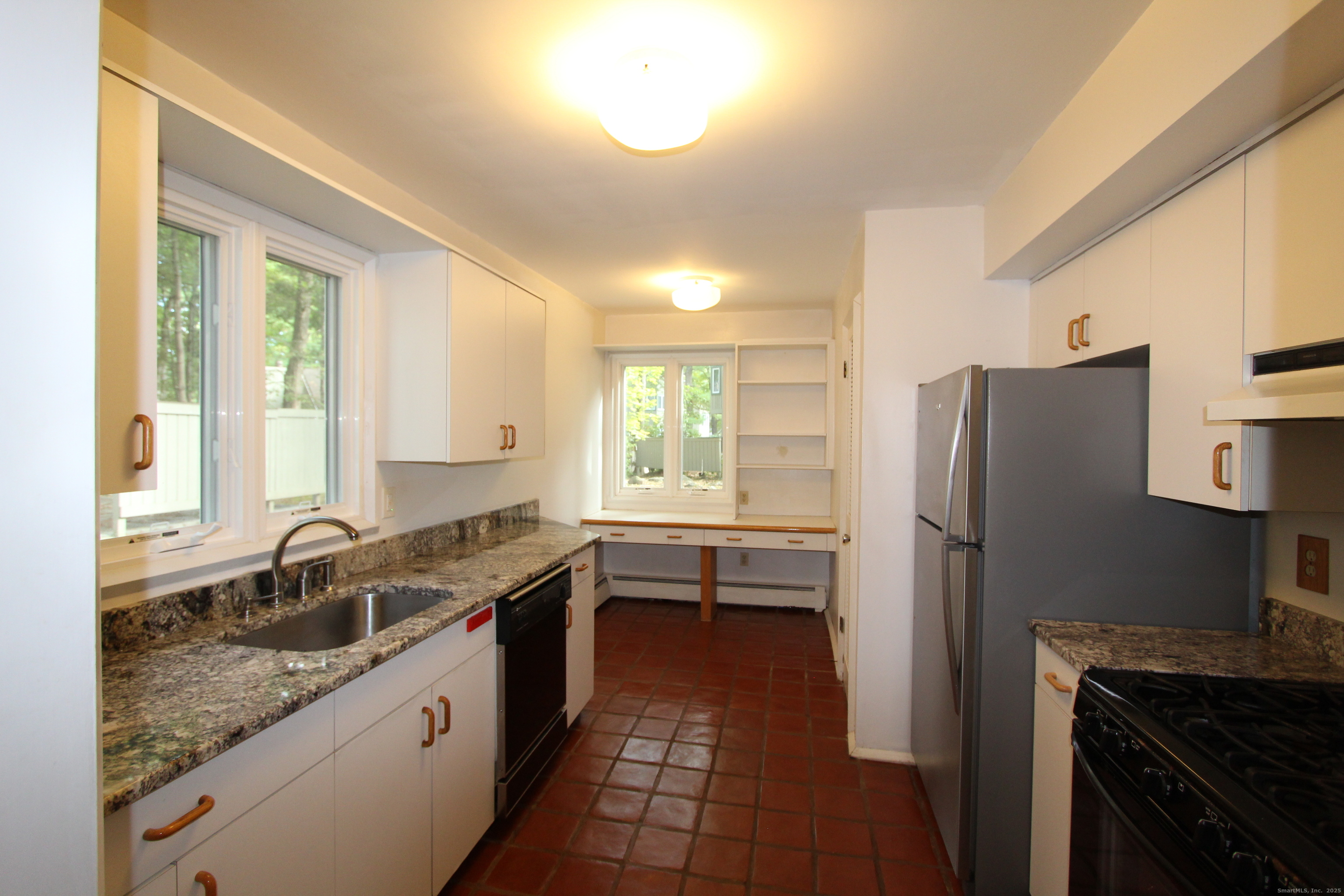 6 Lyle Court, Unit C Farmington, CT 06032 - Photo 8 of 34 a kitchen with a sink stove and refrigerator