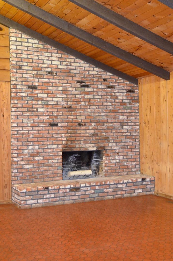 2890 Roop Road Gilroy, CA 95020 - Photo 17 of 22 a stone house with a wooden floor
