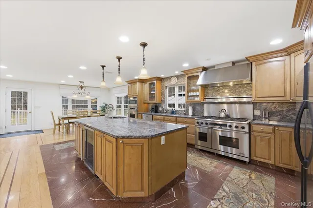 a kitchen with stainless steel appliances granite countertop a stove and a refrigerator