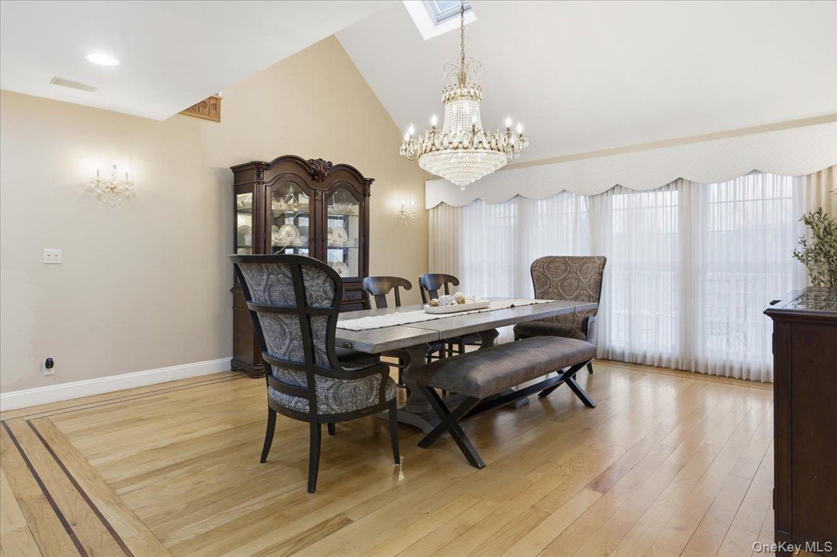 627 Green Lake Road Catskill, NY 12414 - Photo 16 of 50 a view of a dining room with furniture a chandelier and wooden floor