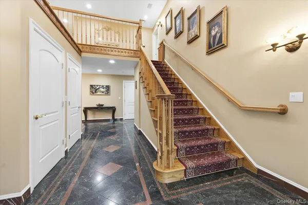 a view of entryway and hall with wooden floor