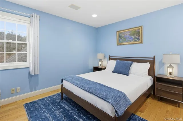 a large bed sitting in a bedroom next to a window