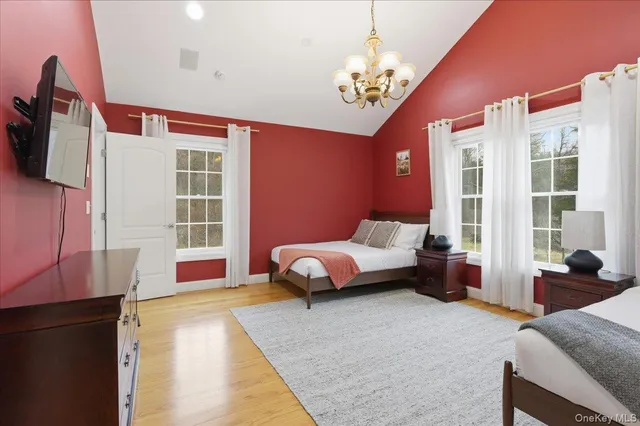 a spacious bedroom with a bed couch and a window