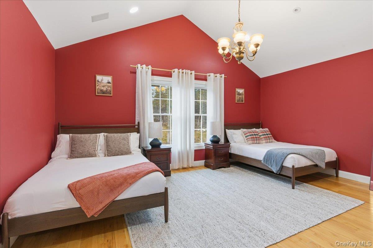 627 Green Lake Road Catskill, NY 12414 - Photo 29 of 50 a bedroom with a bed chandelier and a window