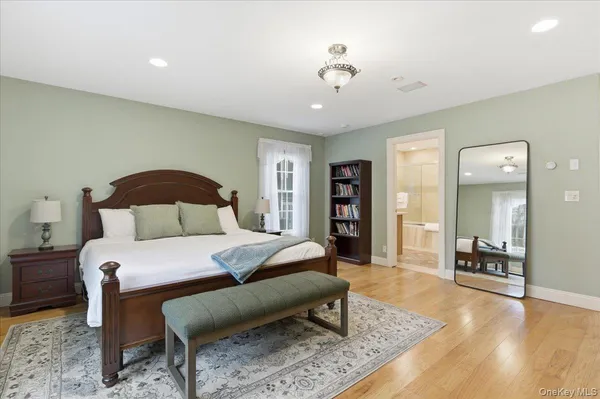 a bedroom with bed and wooden floor