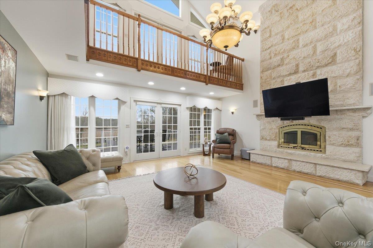 627 Green Lake Road Catskill, NY 12414 - Photo 10 of 50 a living room with furniture a flat screen tv and a fireplace