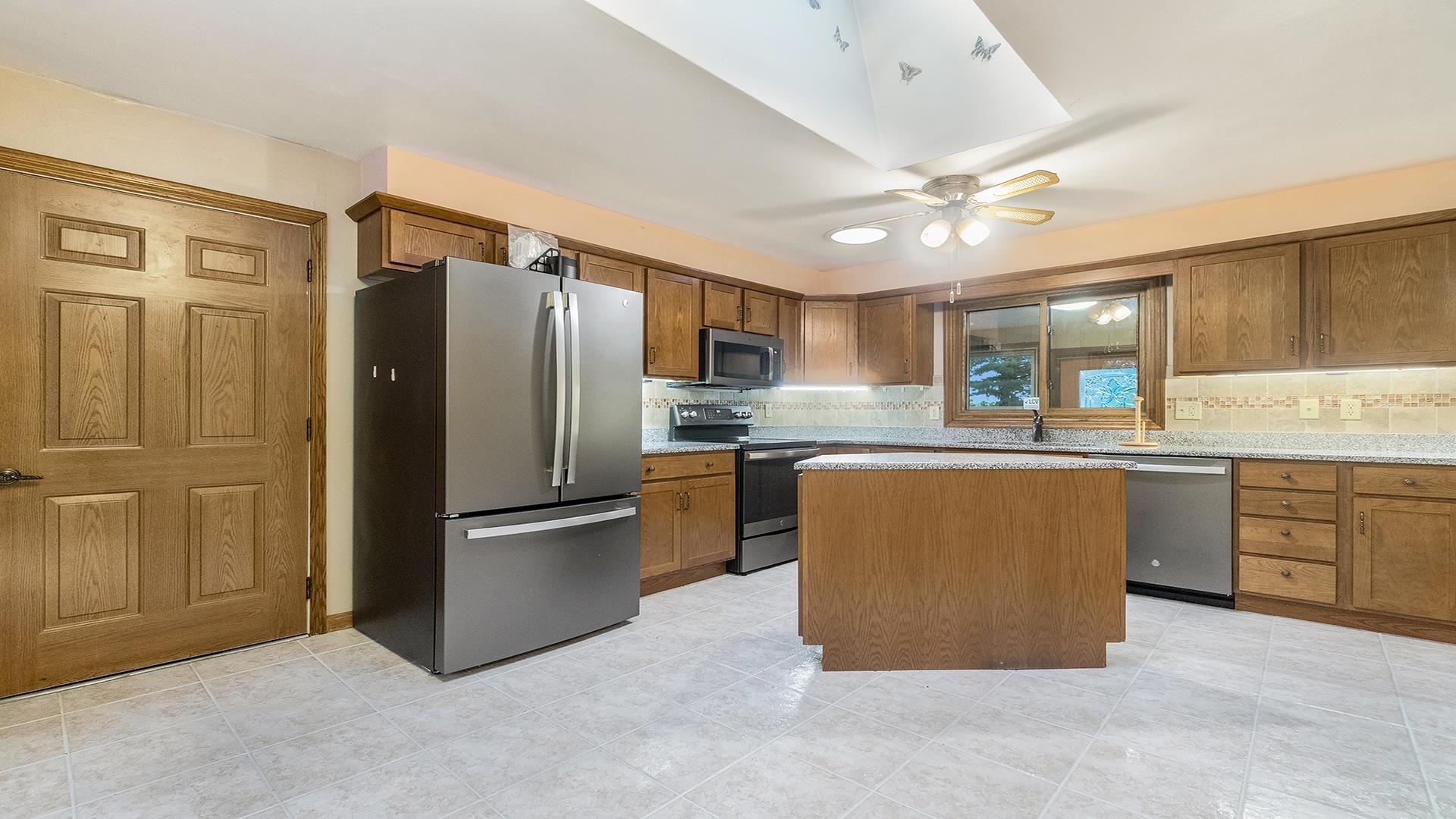 35340 West County Line Road Kirkland, IL 60146 - Photo 14 of 45 a kitchen with stainless steel appliances granite countertop a refrigerator a sink dishwasher and a stove top oven