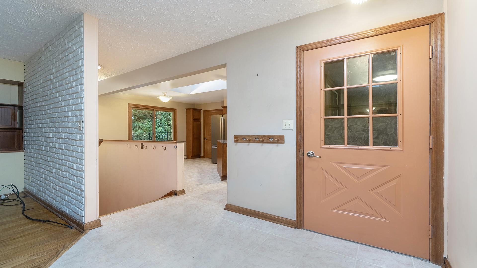35340 West County Line Road Kirkland, IL 60146 - Photo 21 of 45 a view of an entryway with wooden floor and a kitchen
