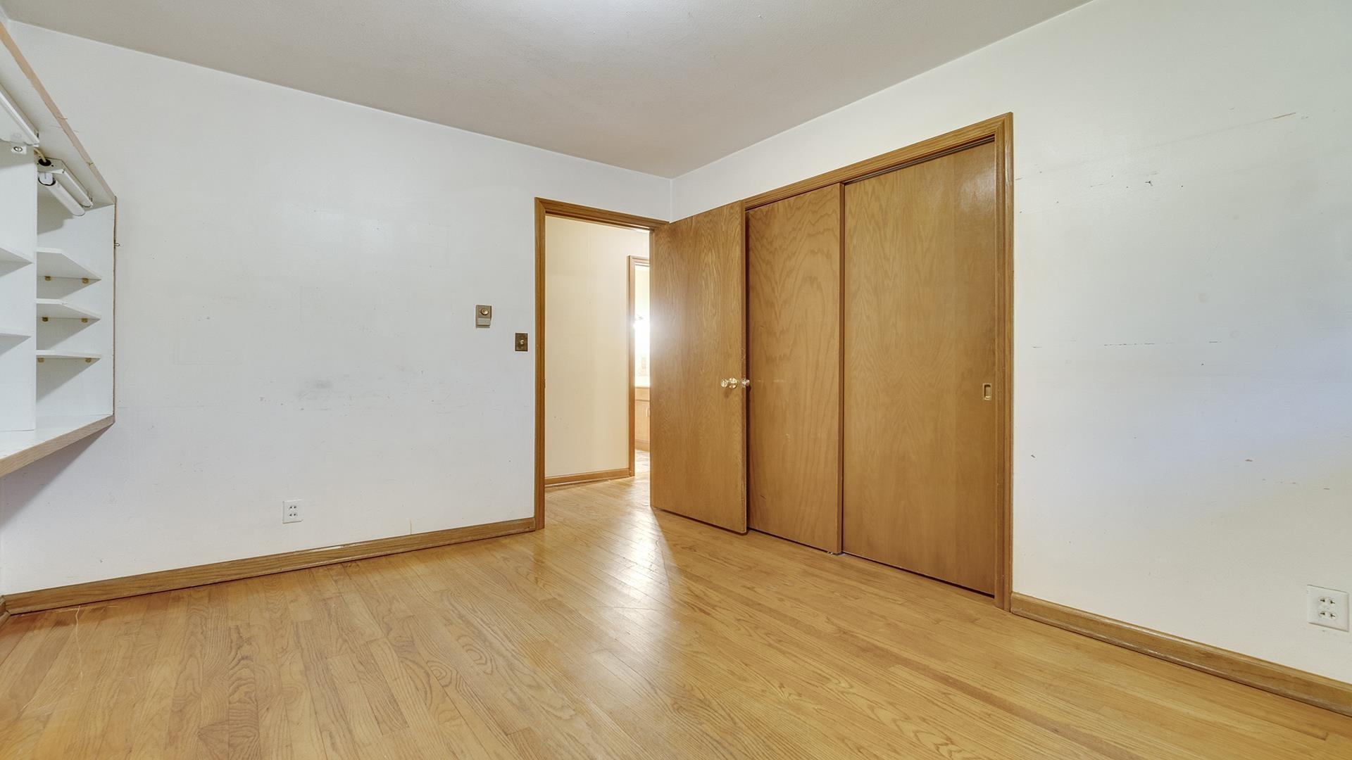 35340 West County Line Road Kirkland, IL 60146 - Photo 27 of 45 a view of an empty room with wooden floor and a window
