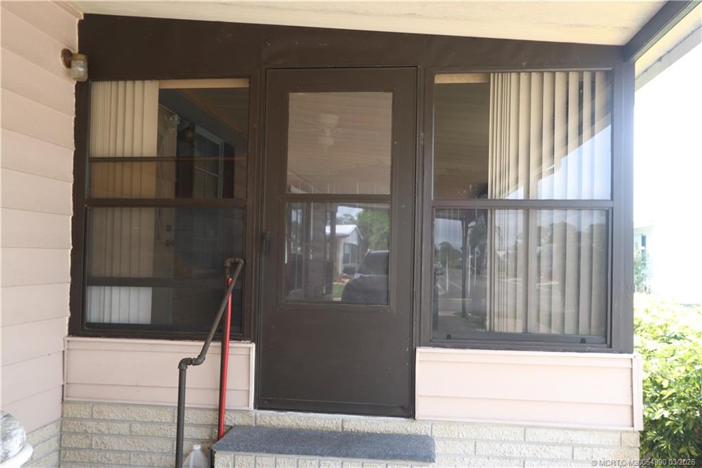 14413 Southwest Rake Drive Indiantown, FL 34956 - Photo 4 of 21 Lanai for outdoor seating with windows & screens.