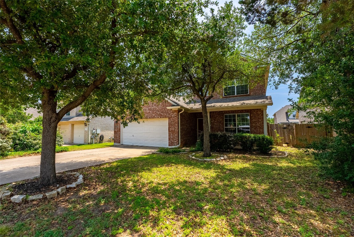 a view of a house with a yard and tree s
