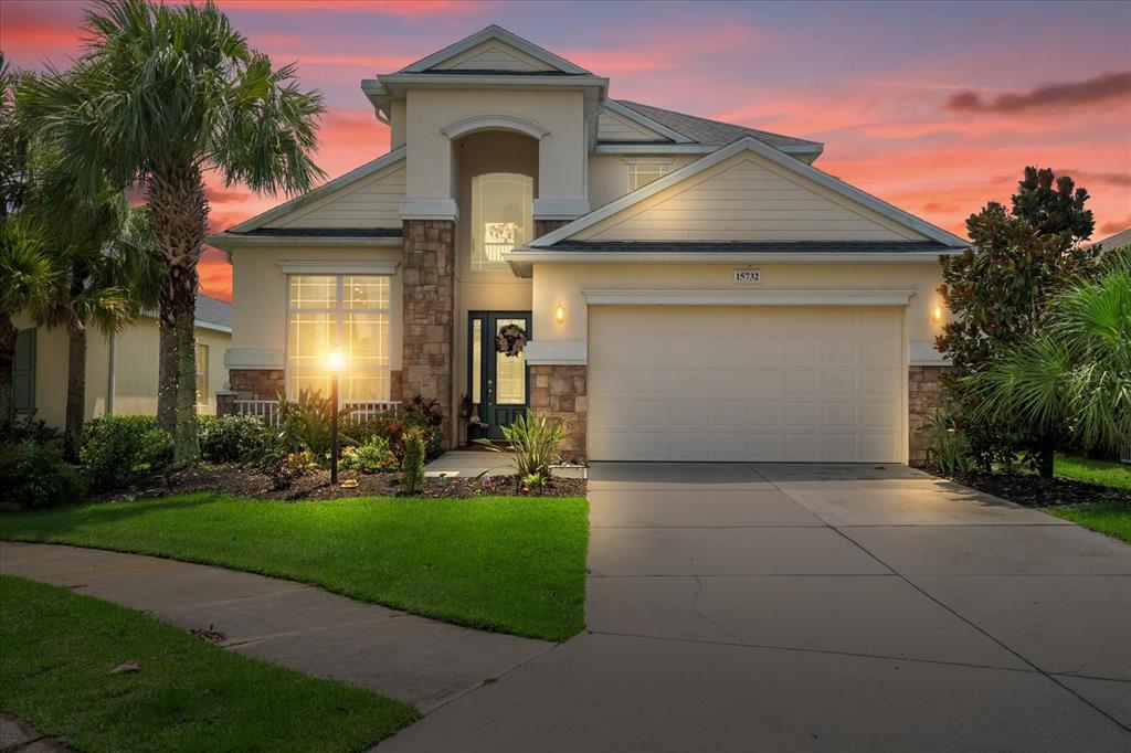 15732 Butterfish Place Lakewood Ranch, FL 34202 - Photo 1 of 1 a front view of a house with a yard and garage