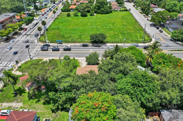 an aerial view of a house with a yard and outdoor seating