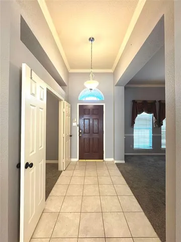 a view of a hallway with a chandelier