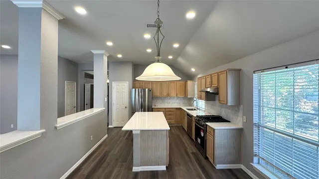 a kitchen with a sink appliances and cabinets