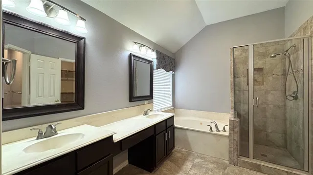 a bathroom with a double vanity sink mirror and shower