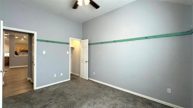 an empty room and chandelier fan in a room