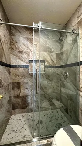 a bathroom with a shower and toilet