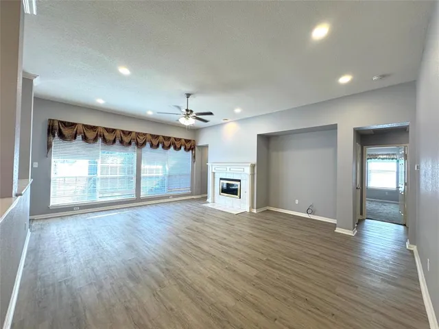 a view of a livingroom with wooden floor and window